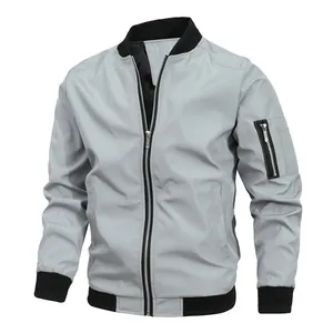 Detailed macro view of a light grey men's bomber jacket with black ribbed cuffs.