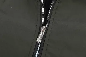 Close-up detail of high-quality silver metallic zipper on dark olive casual men's jacket