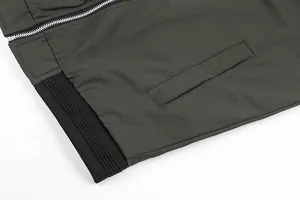 Detailed macro view of men's casual jacket featuring silver zipper and black ribbed hem