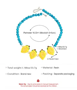 Macro detail of vibrant blue bead necklace featuring yellow resin lemon charms and measurements.