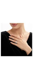Close-up detail of an elegant moissanite silver ring being worn on a woman's finger