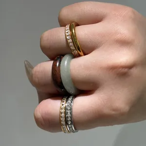 Close-up of stackable titanium steel rings with natural stones and crystals.
