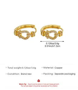 Detailed view of gold U-link hoop earrings with zircon pavé and measurements