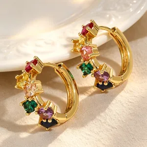 Detailed macro view of gold-plated hoop earrings with vibrant multi-colored zircons