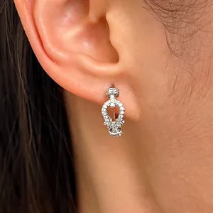 Detailed macro view of a sparkling silver buckle ear hoop encrusted with pavé cubic zirconia