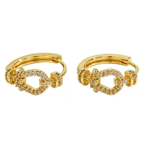 Detailed close-up of vintage gold hoop earrings encrusted with cubic zirconia stones