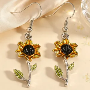 Detailansicht der Emaille-Sonnenblumen-Ohrhänger mit gelben Blütenblättern und Blättern