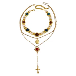 Vintage multi-layer gold chain necklace featuring cross heart pendants and faux pearls
