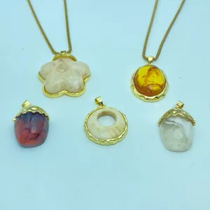 Variety of vintage resin pendants with gold-plated edges and amber textures