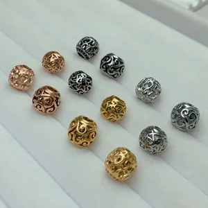 Detailed macro view of hollow stainless steel round beads in multiple metallic finishes