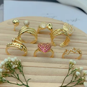 Detailed view of gold plated micro-pave zircon rings in heart and fan shapes