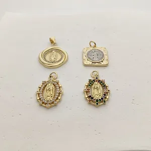 Detailed view of four golden Virgin Mary and San Benito pendants with colorful zircons.
