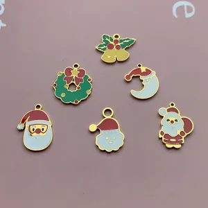 Detailed view of six colorful enamel Christmas charms including Santa Claus and bells