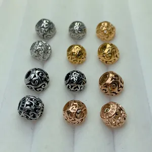 Macro detail of various filigree hollow beads with heart patterns for DIY jewelry