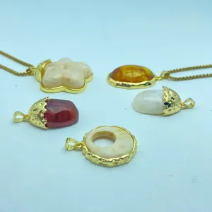 Detailed macro view of various vintage resin amber pendants with gold-plated frames