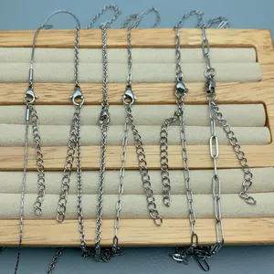 Variety of stainless steel necklace chains for DIY jewelry making on a display board.
