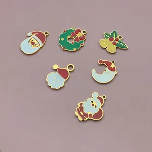 Detail view of colorful cartoon Christmas charms for DIY jewelry making accessories.