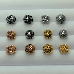Macro view of vintage hollow stainless steel charm beads in gold silver and rose gold