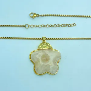 Detail of retro resin flower pendant necklace with gold-plated chain and amber texture