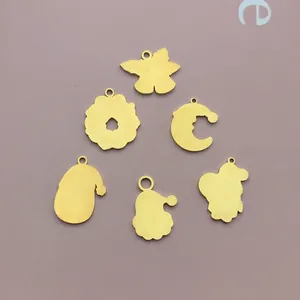 Detailed view of six gold-plated stainless steel Christmas charms for DIY jewelry crafts