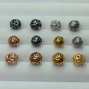 Detailed view of hollow filigree stainless steel spacer beads in various metallic colors