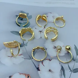 Macro view of various vintage gold-plated open rings with zircon heart and fan designs