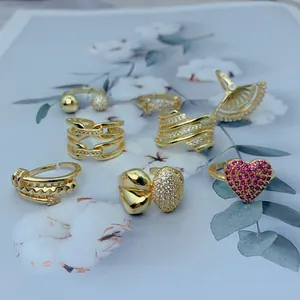 Assortment of vintage gold plated rings with micro-pave zircon heart and fan designs
