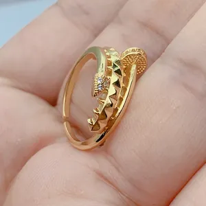 Close-up of gold-plated open ring featuring micro-pave cubic zirconia and unique geometric spikes.