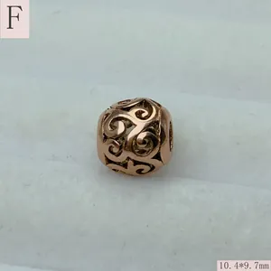 Macro detail of vintage rose gold stainless steel hollow filigree round spacer bead