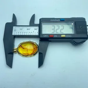 Detailed size measurement of vintage amber resin pendant showing 32.2mm width
