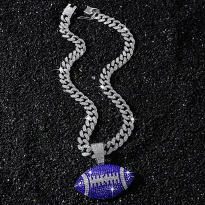 Detail view of an iced-out Cuban link chain featuring a blue pavé rhinestone football.