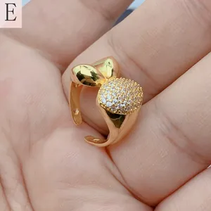 Detailed close-up view of a gold-plated open ring featuring shimmering micro-pave zircons