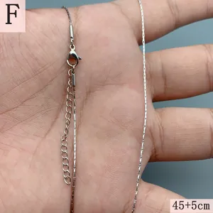 Close-up of silver stainless steel chain with lobster clasp and extension chain