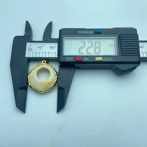 Close-up of vintage resin pendant measured at 22.8mm with digital caliper