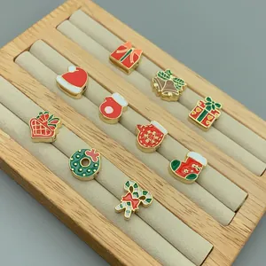Detailed view of colorful Christmas enamel charms on a jewelry display tray.