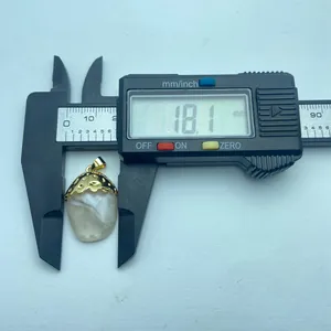 Detailed measurement of vintage resin pendant with gold-plated floral cap, 18.1mm width.