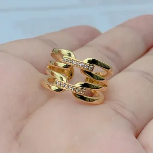 Detailed view of a gold-plated geometric hollow ring with micro-set zircon accents on hand.