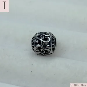 Close-up of retro hollow stainless steel round bead, 9.8x9.8mm, for DIY jewelry making.