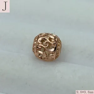 Macro detail of a rose gold hollow filigree bead measuring 9.8x9.8mm