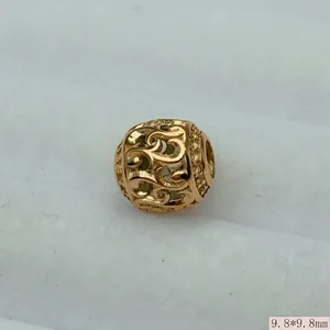 Macro detail of vintage gold hollow stainless steel round charm bead for DIY jewelry