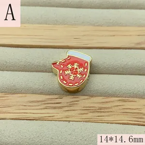 Detailed view of red Christmas mitten bead with white trim and golden snowflake