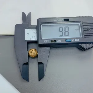 Detail view of a golden hollow stainless steel bead measured at 9.8mm for DIY jewelry
