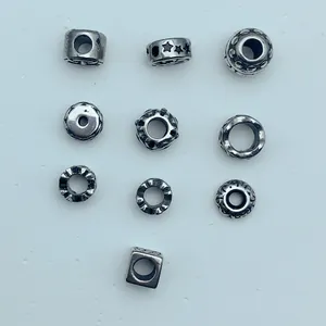Detailed close-up showing various vintage stainless steel spacer beads for DIY jewelry making