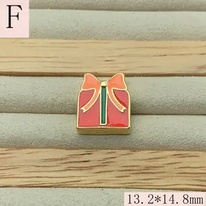 Detailed close-up of a red enamel Christmas gift box bead with 13.2x14.8mm size
