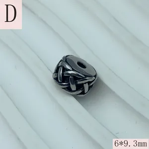 Detailed view of a stainless steel woven spacer bead for DIY jewelry crafting.