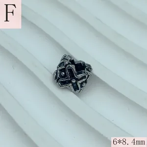 Close-up of antique silver stainless steel spacer bead with cross pattern, 6x8.4mm.