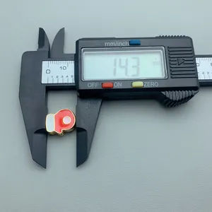 Red enamel Christmas sock charm detail showing 14.3mm measurement on digital caliper.