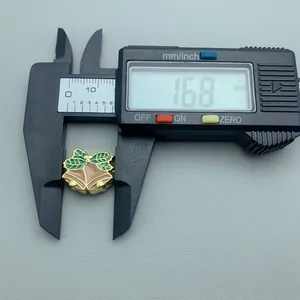 Detailed macro view showing the measurement of a Christmas bell enamel charm with digital caliper