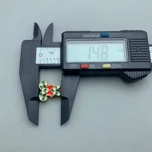 Detail shot of Christmas candy cane enamel charm measured with a digital caliper at 14.8mm.