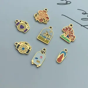 Detailed view of colorful stainless steel enamel charms in mushroom and camera shapes